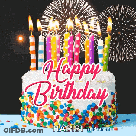A Happy Birthday Cake With Candles And Fireworks In The Background . GIF