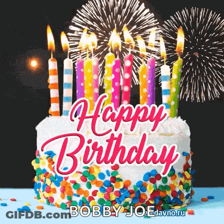 A Happy Birthday Cake With Candles And Fireworks In The Background . GIF