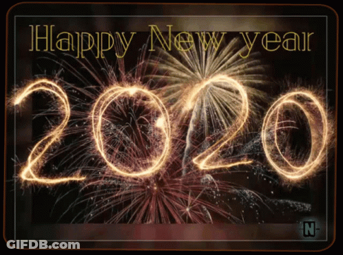 A Happy New Year Greeting Card With Fireworks Behind The Number 2020 GIF