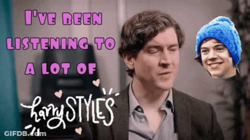 A Harry Styles Poster With A Man Wearing A Blue Hat GIF
