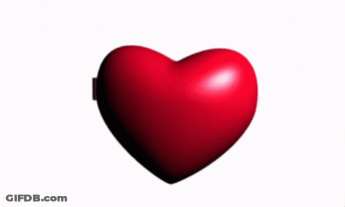 A Heart Shaped Mirror Has A Picture Of A Man Wearing Glasses GIF