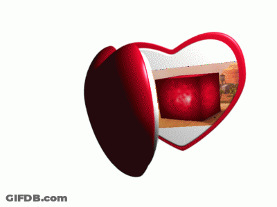 A Heart Shaped Mirror With A Desert Scene On It GIF