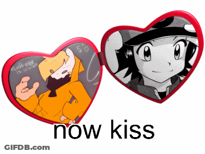 A Heart Shaped Mirror With A Picture Of A Boy And A Girl And The Words Now Kiss Below It GIF