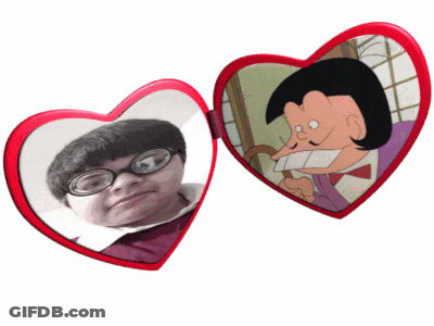 A Heart Shaped Mirror With A Picture Of A Man In Glasses GIF