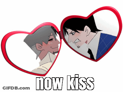 A Heart Shaped Mirror With A Picture Of Two Men And The Words Now Kiss On The Bottom GIF