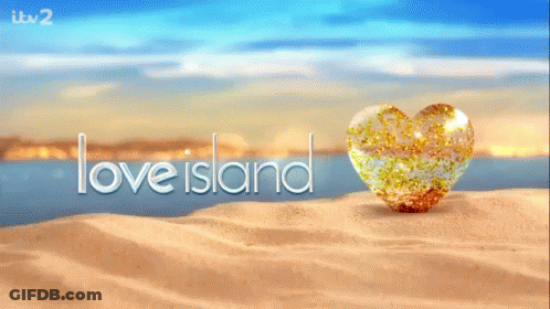 A Heart Shaped Object On A Sandy Beach With The Words Love Island In The Background GIF