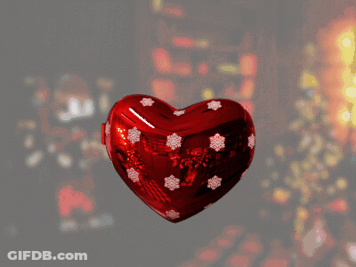 A Heart Shaped Ornament With A Coyote Wearing A Santa Hat Says Merry Christmas Wile E Coyote GIF
