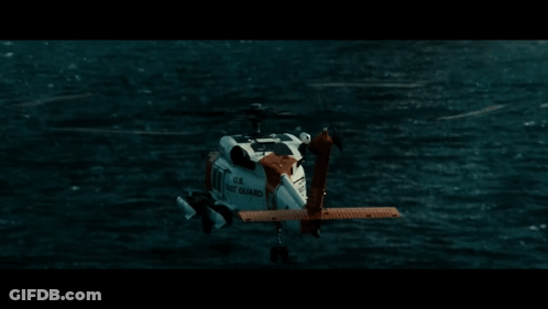A Helicopter From The U.s. Navy Is Flying Over A Body Of Water GIF