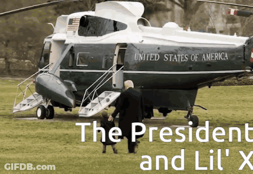 A Helicopter From The United States Of America Is Parked In A Grassy Field GIF