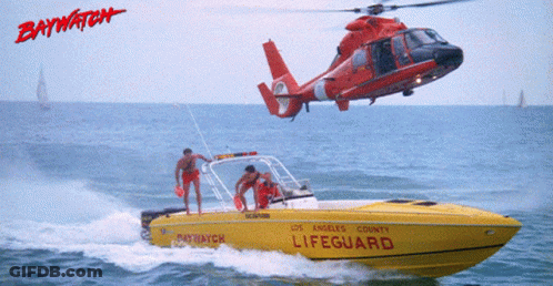 A Helicopter Is Flying Over A Yellow Lifeguard Boat GIF