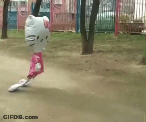 A Hello Kitty Shaped Balloon Is Flying Through The Air GIF