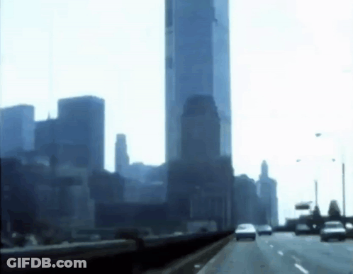 A Highway With A City Skyline In The Background GIF
