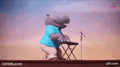 A Hippopotamus Is Playing A Keyboard And Singing Into A Microphone GIF