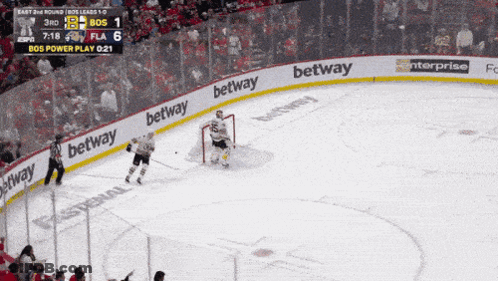 A Hockey Game Is Being Played And The Betting Advertisements Are On The Ice GIF