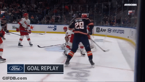 A Hockey Game Is Being Played And The Goal Replay Is Displayed On The Screen GIF
