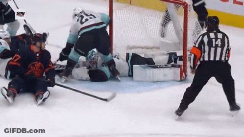 A Hockey Game Is Being Played And The Referee Has The Number 14 On His Jersey GIF