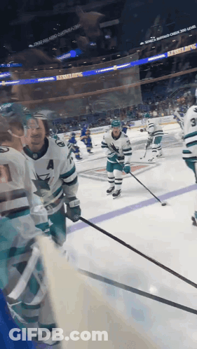 A Hockey Game Is Being Played In A Stadium That Has A Banner That Says ' Reebok ' On It GIF