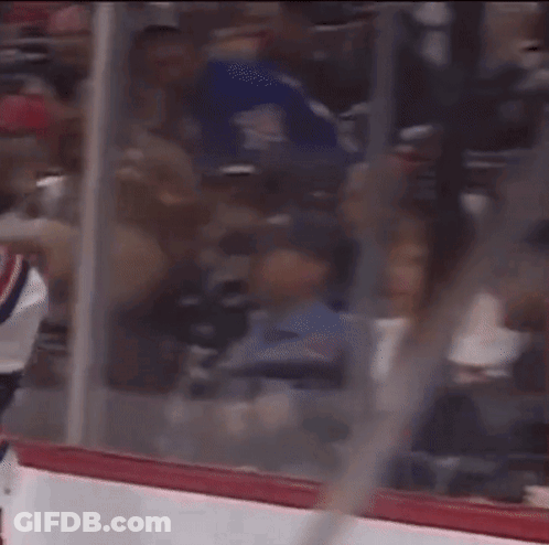 A Hockey Game Is Being Played In A Stadium With A Lot Of People In The Stands GIF