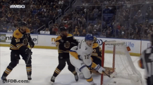 A Hockey Game Is Being Played In A Stadium With A Msg Logo On The Ice GIF