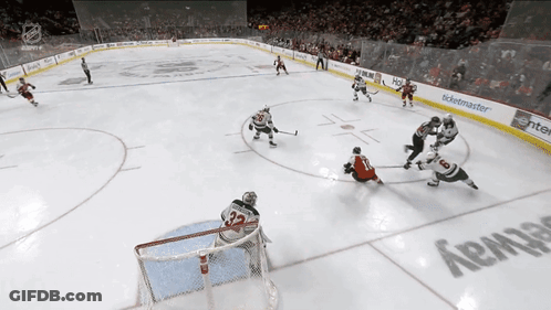 A Hockey Game Is Being Played In A Stadium With A Ticketmaster Advertisement On The Wall GIF