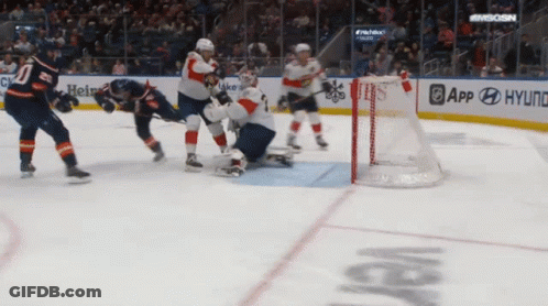 A Hockey Game Is Being Played In Front Of A Banner For Hyundai GIF