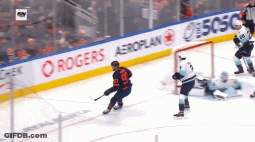 A Hockey Game Is Being Played In Front Of A Banner For Rogers Aeroplan GIF