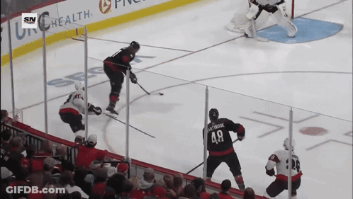 A Hockey Game Is Being Played In Front Of A Banner For Sn Health GIF