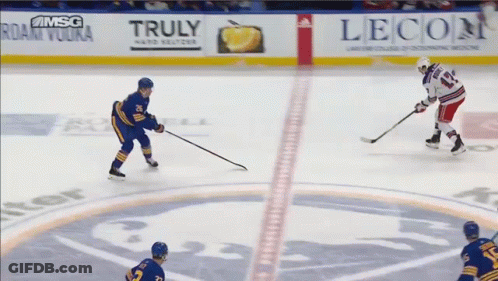 A Hockey Game Is Being Played In Front Of A Banner For Truly Vodka GIF