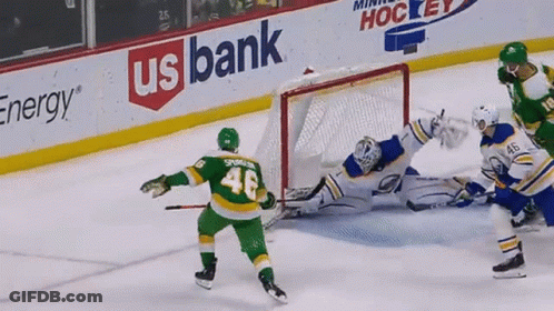 A Hockey Game Is Being Played In Front Of A Banner For Us Bank GIF