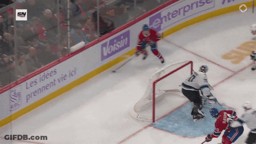 A Hockey Game Is Being Played In Front Of A Banner For Voisin Enterprise GIF