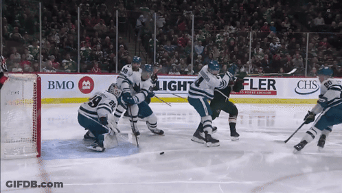 A Hockey Game Is Being Played In Front Of A Banner That Says Chs GIF