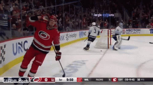 A Hockey Game Is Being Played In Front Of A Banner That Says Vector Security GIF