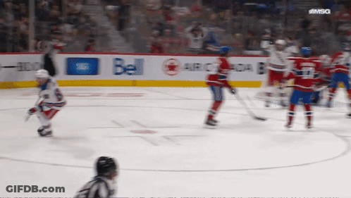 A Hockey Game Is Being Played In Front Of A Bell Ad GIF