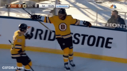 A Hockey Game Is Being Played In Front Of A Bridgestone Sign GIF