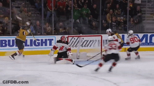 A Hockey Game Is Being Played In Front Of A Bud Light Banner GIF