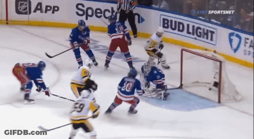 A Hockey Game Is Being Played In Front Of A Bud Light Sign GIF