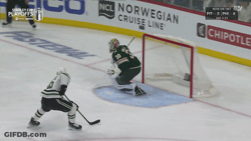 A Hockey Game Is Being Played In Front Of A Chipotle Advertisement GIF