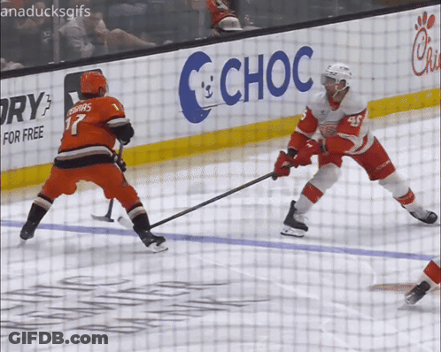 A Hockey Game Is Being Played In Front Of A Choc Sign GIF