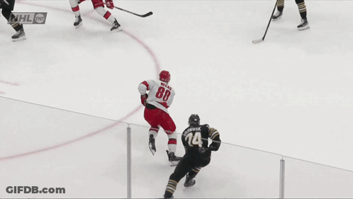 A Hockey Game Is Being Played In Front Of A Coca Cola Ad GIF