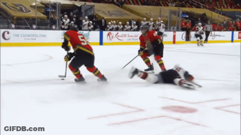 A Hockey Game Is Being Played In Front Of A Cosmopolitan Sign GIF