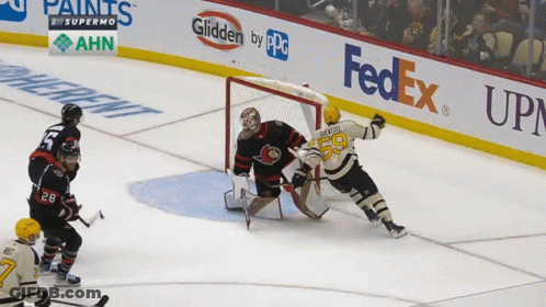 A Hockey Game Is Being Played In Front Of A Fedex Sign GIF
