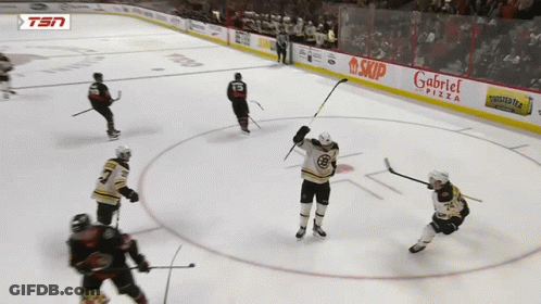 A Hockey Game Is Being Played In Front Of A Gabriel Pizza Sign GIF