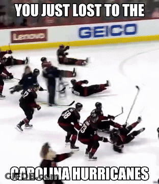 A Hockey Game Is Being Played In Front Of A Geico Ad GIF