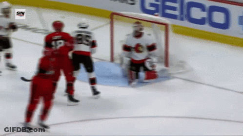 A Hockey Game Is Being Played In Front Of A Geico Advertisement GIF