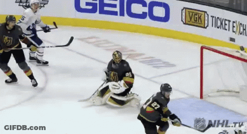 A Hockey Game Is Being Played In Front Of A Geico Sign GIF