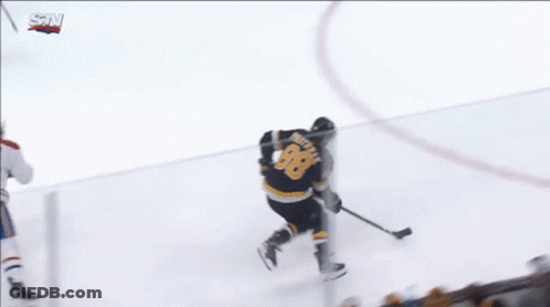 A Hockey Game Is Being Played In Front Of A Jetblue Sign GIF