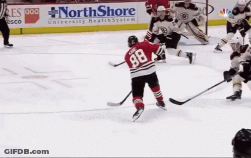 A Hockey Game Is Being Played In Front Of A Northshore University Health System Sign GIF