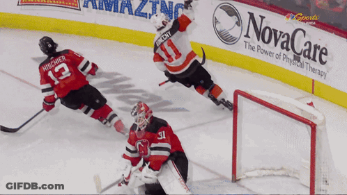 A Hockey Game Is Being Played In Front Of A Novacare Banner GIF