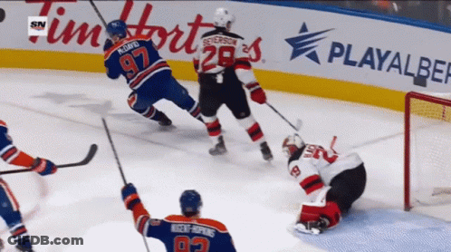 A Hockey Game Is Being Played In Front Of A Playalber Sign GIF