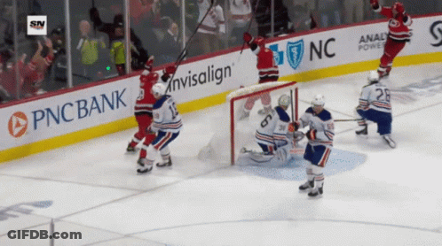 A Hockey Game Is Being Played In Front Of A Pnc Bank Advertisement GIF